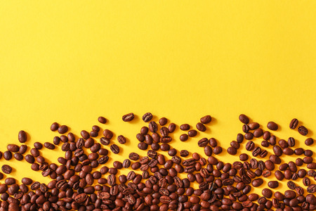 Coffee beans as a background isolated on yellow background.の写真素材