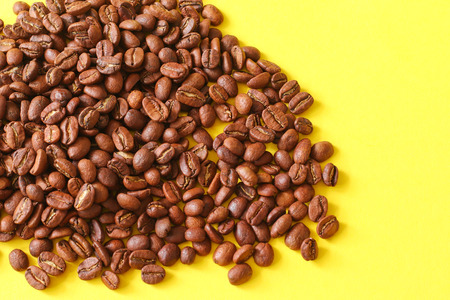 Coffee beans as a background isolated on yellow background.の写真素材