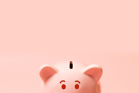 Piggy bank on living coral background. Commercial concept. Commercial concept.Top view point, flat lay.の写真素材