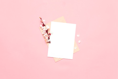 Paper blank and spring flowers on pink background. Mockup with flowers.の写真素材