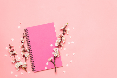 Flat lay composition gift box and notebook on pink background with space.の写真素材