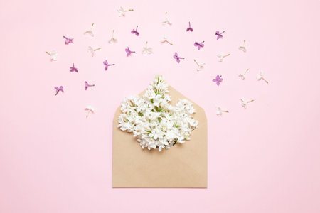 Envelope with branches of lilac decor on pink background