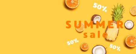 Juicy tropical fruits on a yellow background: oranges, coconuts, lemons, pineapples.の写真素材