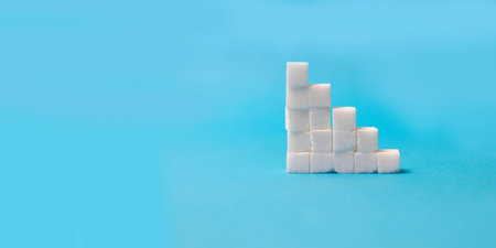 Concept leader of sugar stairs on blue background.