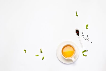 Tea composition background of cup of tea, green tea, black tea, ceramic spoon on a gray background. Flat lay, top view.の写真素材