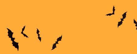Halloween banner with black bats on an orange background, top view. Poster, voucher, offer, coupon, holiday sale.の写真素材