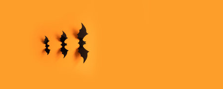 Halloween banner with black bats on an orange background, top view. Poster, voucher, offer, coupon, holiday sale.の写真素材