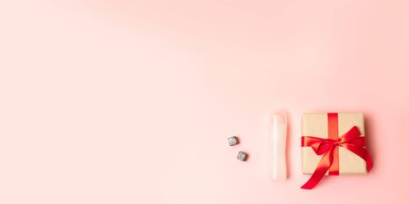 Congratulations on March 8, birthday, Valentines Day. Surprise gift boxes with red bow ribbons, nail polish and red clock on a pink background with place for text.の写真素材