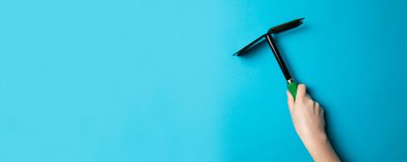 Metal double gardening hoe isolated on a blue background. Garden tools and equipment isolatedの写真素材