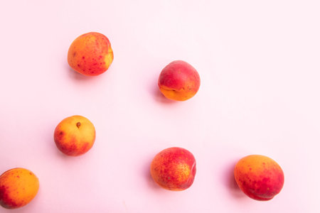 Flat composition of sweet juicy peaches on pink backgroundの写真素材
