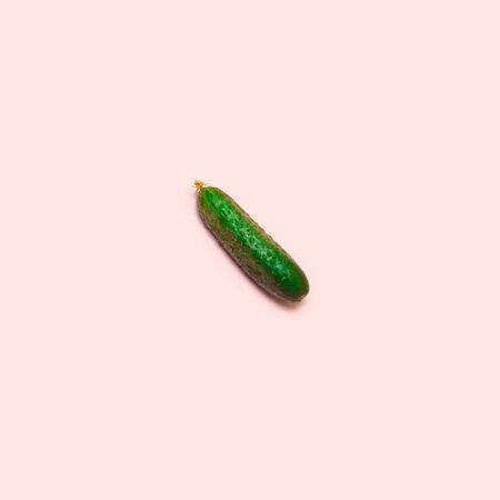 Food concept. Creative flat lay of a cucumber on a pink background, top viewの写真素材