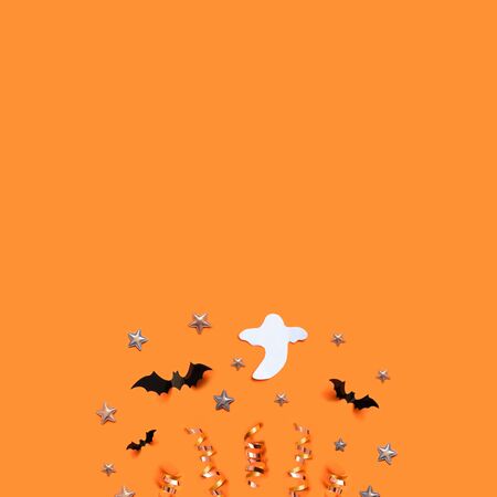 Halloween holiday background with bats, stars and decorations on an orange board. View from above. Flat layの写真素材