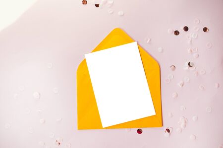 Creative composition with paper blank and yellow craft envelope on black table overhead for wedding mockup flat lay. Horizontal locationの写真素材