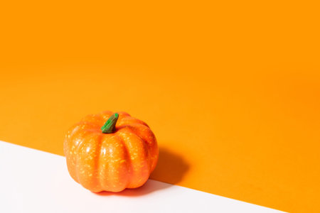 Autumn composition, halloween concept. Pumpkin on orange background. Empty space for your text.