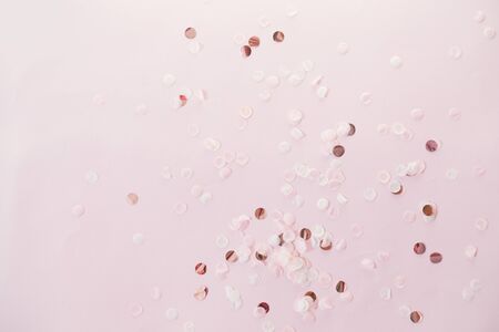 Christmas golden shiny decorations on color background. Creative layout. Flat lay, top view. Festive pastel background.の写真素材