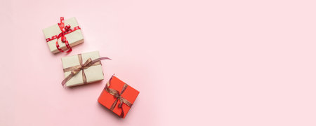 Minimal christmas newyear concept of Christmas red gift boxes, balls on pastel pink background.