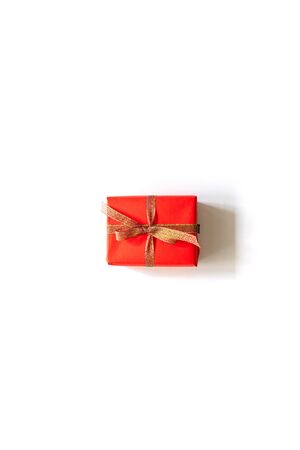 Creative Christmas composition of gift box with gold tape on white background. Flat lay, top view, copy spaceの写真素材