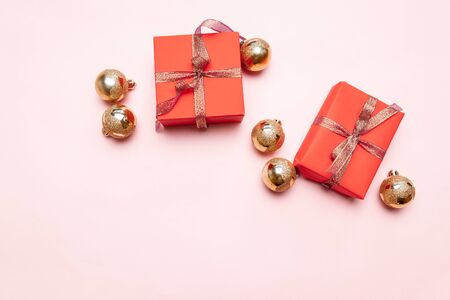Minimal christmas newyear concept of Christmas red gift boxes, balls on pastel pink background. Creative flat lay, top view designの写真素材