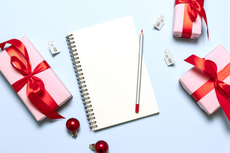 Goals plans dreams make to do list. New year winter holiday xmas concept writing in notebook with...