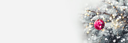 Festive Christmas tree decorated with glass gold balls toys on sparkling background with beautiful...