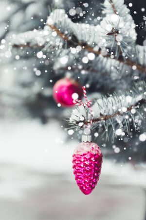 Festive Christmas tree decorated with glass gold balls toys on sparkling background with beautiful bokeh, copy space. Winter landscape with snow and christmas trees.の写真素材