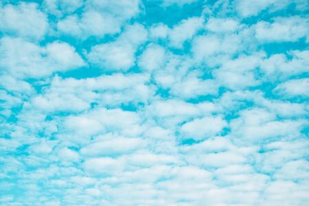 Fluffy white clouds soar in the blue sky. Minimal backgroundの写真素材
