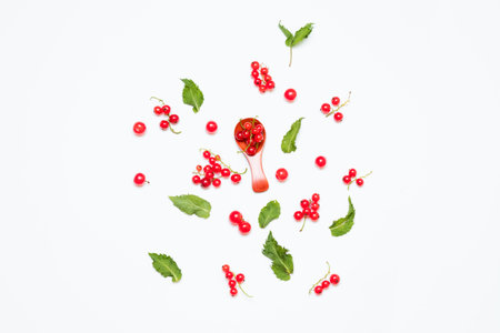 Ripe red currant berries and green mint leaves isolated on white background. Summer composition