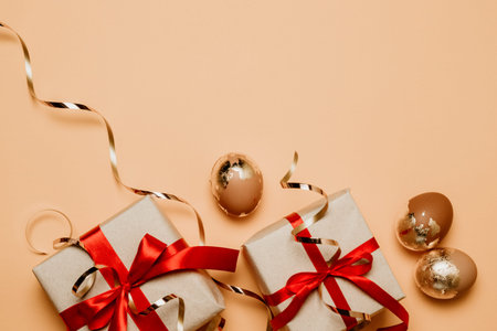 Stylish background with gold easter eggs, gift boxes with copy space for text. Flat lay, top view. Easter concept.の写真素材