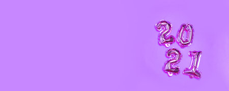 Minimal holiday composition with silver balloons on a lilac background with copy space. Happy new...