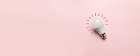 An hour without light on the whole planet. Energy saving lamp with copyspace on a pink background....