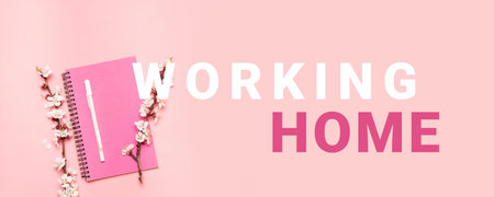 Top view of notebook, pen and cherry flowers twig with text on pink background. Freelance, work at...