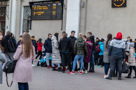 Odessa, Ukraine - March 11th 2020: Crowd of young and adult people at the station are waiting for...