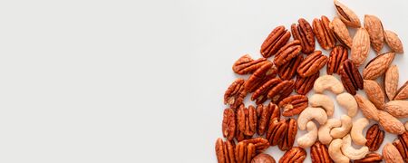 Top view of assorted nuts on gray background with copy space on a gray backgroundの写真素材