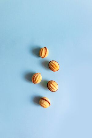 Vertical photo, flat lay of nut cookies on a blue backgroundの写真素材