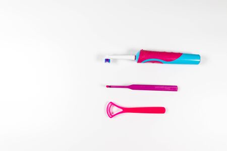 Ultrasonic pink toothbrush and dental hygiene products on a grey backgroundの写真素材