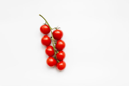 Fresh cherry tomatoes on a white background