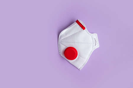 Top view of protective medical mask with valve on colored background with copy spaceの写真素材