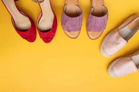 Trendy collection of women shoes on a yellow background. Beauty and fashion concept. Top view, flat layの写真素材