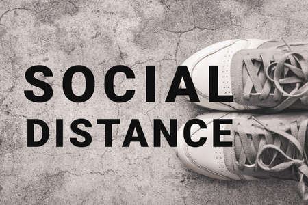 Social Distancing concept. Shoes with text Social Distance.の写真素材