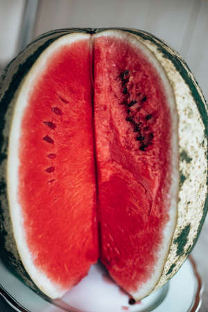 Slice watermelon on a white plate. Vertical photo orientation. Food Backrgound.の写真素材
