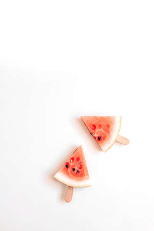 Ripe slice of watermelon in the form of a lelen on a stick on a white backgroundの写真素材