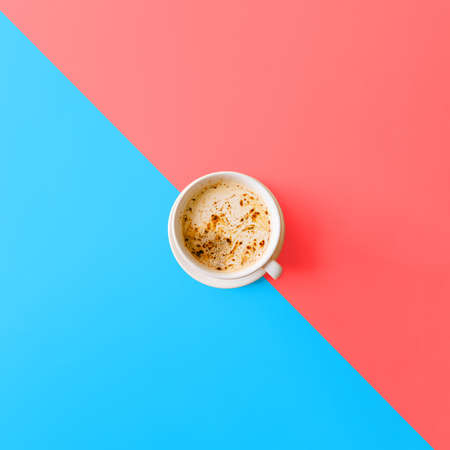 Delicious morning cappuccino or flat white on pink blue background. Top view with copy space, flat layの写真素材
