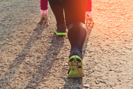 Sportsman beginning race with low start. Preparation for the marathon, competitions, personal...