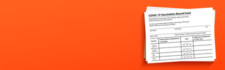 Coronavirus vaccination record card on a orange background with copy space for travel and movement...