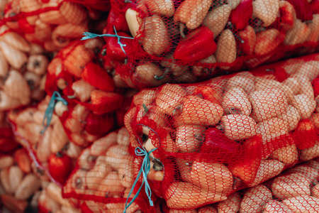 Fresh organic healthy vegetables at grocery store. Vegetables in mesh bags on marketの写真素材