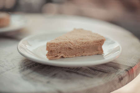 Homemade Napoleon cake on a table in a street restaurant. Tasty morning foodの写真素材