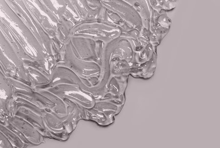 Liquid cream gel cosmetic smudge drops texture grey backgroundの写真素材