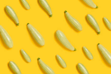 Composition with fresh organic vegetable marrow on yellow color background, top view with space for textの写真素材