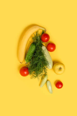 Eco friendly summer organic vegetables on yellow background, space for text. Flat lay, top view. Healthy clean eating diet and detoxの写真素材