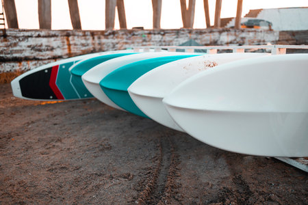 Summer paddle board or SUP board rent in tropical beach shore. Water sport,